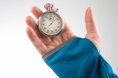 hand with a mechanical stopwatch on a white background.