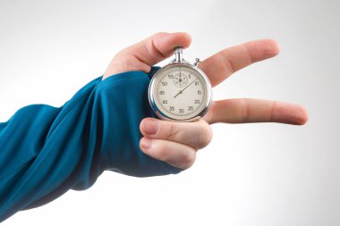 hand with a mechanical stopwatch on a white background. Time part precision. Measurement of the speed interval