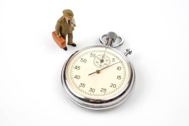 miniature people. mechanical stopwatch on the background of business people. Part time accuracy for business. business and finance time