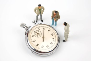 miniature people. mechanical stopwatch on the background of business people. Part time accuracy for business. business and finance time