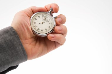 hand with a mechanical analog stopwatch on a white background. Time part precision. Measurement of the speed interval