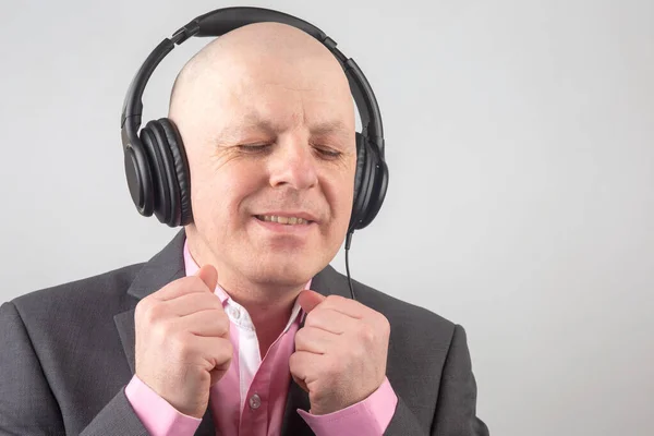 Man Closed Eyes Listens Music Headphones Light Background — Stock Photo, Image