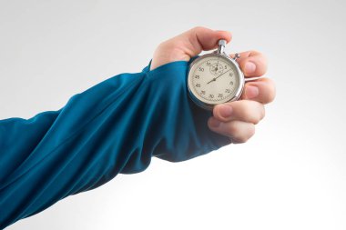 hand with a mechanical stopwatch on a white background. Time part precision. Measurement of the speed interval