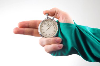 hand with finger direction pointer and mechanical stopwatch on white background. Time part precision. Measuring the speed interval with a watch