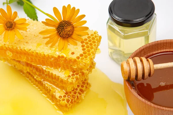 Fresh flower honey in combs and a wooden spoon. vitamin food for health and life