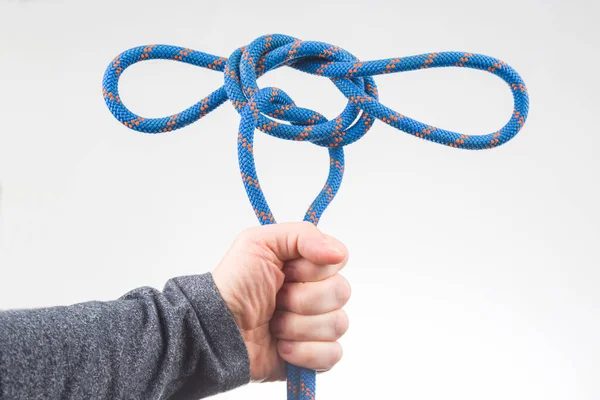 hand holds colored rope for climbing equipment. item for camping and climbing