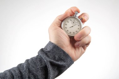 hand with a mechanical stopwatch on a white background. Time part precision. Measurement of the speed interval