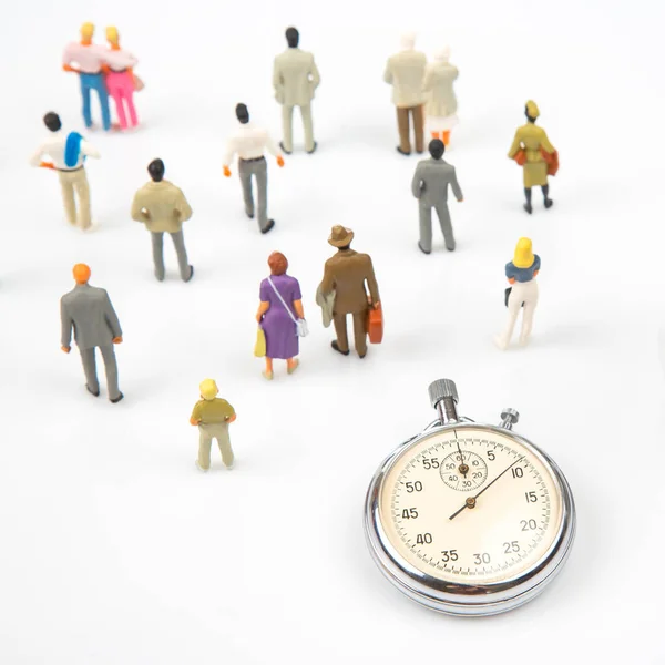 miniature people. mechanical stopwatch on the background of business people. Part time accuracy for business. business and finance time