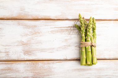 Beyaz ahşap arka planda bir sürü taze kuşkonmaz. Üst görünüm, düz görünüm, kopyalama alanı. hasat, sağlıklı, vejetaryen gıda, konsept, minimalizm.