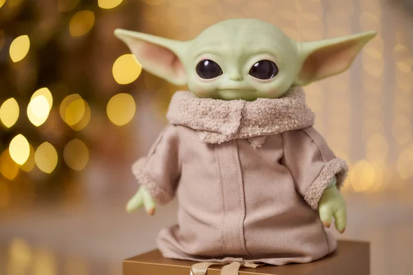 November, 2021: Baby Yoda, an action figures of Mandalorian with christmas decoration interior. Bokeh effect Stock Picture
