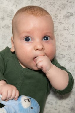 Üç aylık şirin bebek elini yiyor. Diş çıkarma.