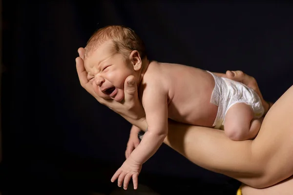 Newborn Baby Arms Dad Black Background — стоковое фото