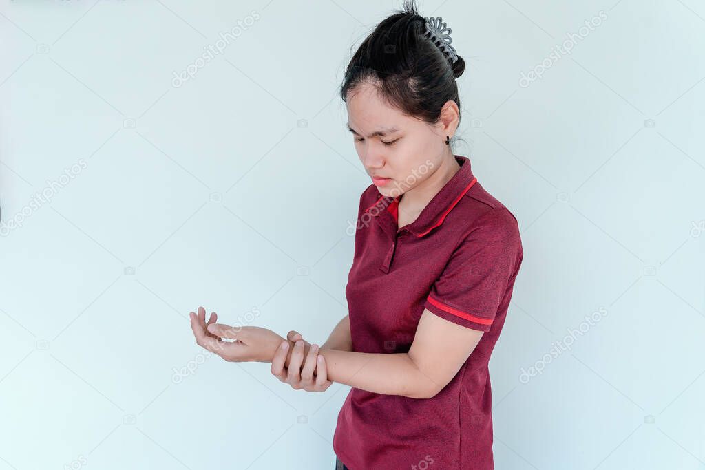 Young woman feeling pain in arm with side effects after receiving vaccination against COVID-19. Unhappy woman showing arm with numbness and pain. Immunization, inoculation and Coronavirus pandemic