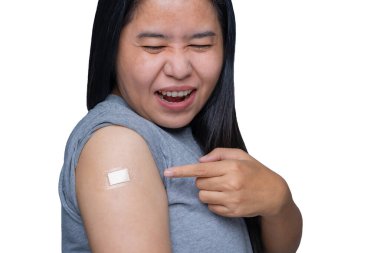Asian middle-aged woman feeling pain and arm muscle pain ache, having some side effects after receiving getting vaccinated immunity with a bandage on her upper arm.  Healthy and medical concept