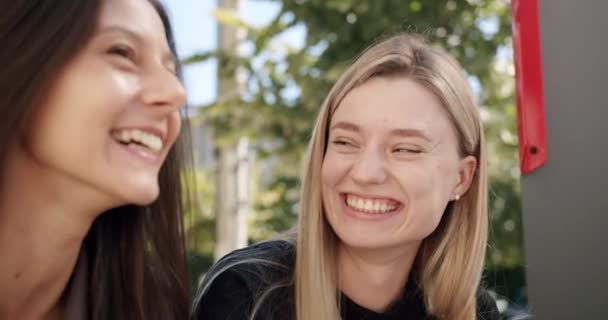 Mooie meisjes glimlachen en praat in de stad, het is een zonnige dag, gelukkige meisjes — Stockvideo