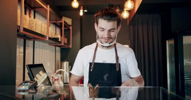 Handsome male bartender handing desserts for tea and coffee, serving concept — Video Stock