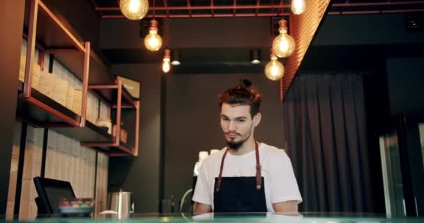 Jóképű férfi csapos főzés és átadás csésze kávé vagy tea, szolgáló koncepció — Stock videók