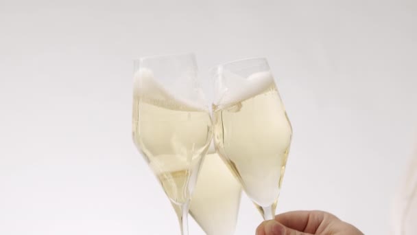 Three glasses collide on a white background, anniversary event — Video Stock