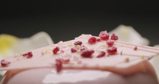 Delicious sweet natural round dessert with pink cream, on a black background — Stock videók