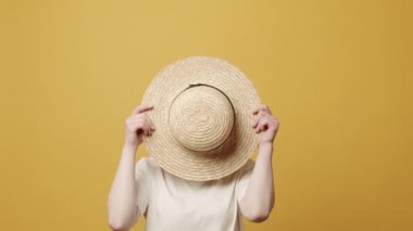  Çekici kadın sarı arka planda farklı yüz ifadeleri yapar.