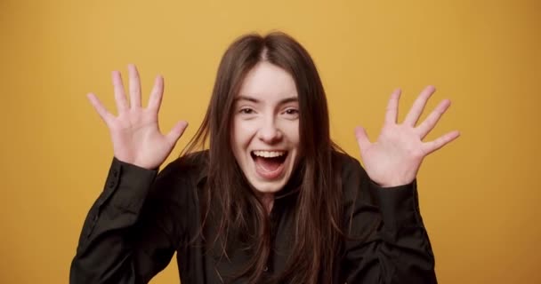 A woman makes an emotional surprise, hiding her eyes with her hands. and Smile — Stock Video