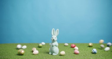 Tavşan Oyuncağı Yeşil Çimenlerin Mavi Arkaplanında Bir sürü renkli yumurta, Metin.