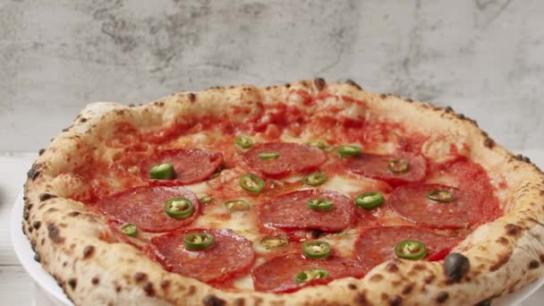 Pepperoni Pizza y pimientos verdes picantes.Deliciosa comida italiana sobre fondo blanco — Vídeos de Stock