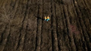 Ukrainian girls in clothes in the colors of the Ukrainian flag on the ground.