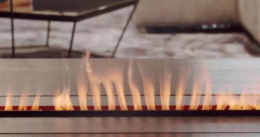 Artificial electronic fireplace burning with smoke fire. Bio fireplace burn.