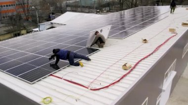 Güneş teknisyenleri evin çatısına güneş panelleri kuruyor. Teknisyen Çalışması.