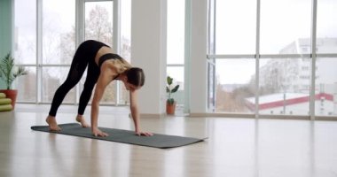 Sporcu kız egzersizden sonra yoga minderinin üstüne çıkıyor. Antrenmanı bitirdim. Karın bölgesini pompalayan kadın. Çapraz Fitness, karnını eğit ve antrenmanı bitir. Evde Günlük Egzersizler