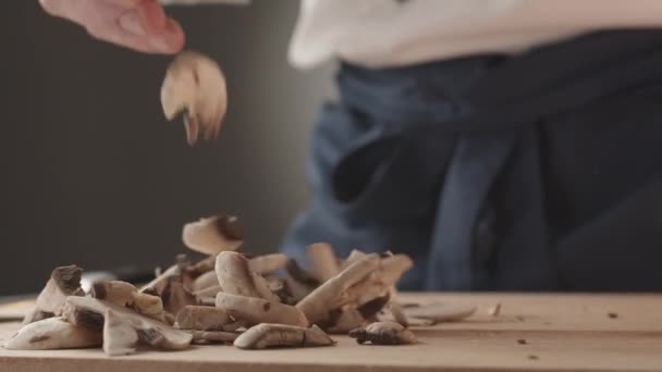 Young Chef Restaurant Uniform Works Kitchen Holds Mushrooms His Hand — Stock Video