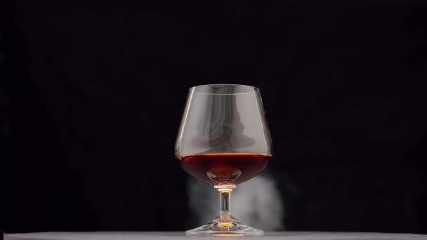 Luxury Brandy Glass Golden Cognac Isolated Black Background Smoke Brandy — Stock Video
