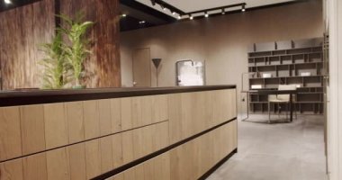 Modern wooden kitchen room furniture. Elegant, Comfortable and Minimalist Home. Domestic Kitchen with modern black sink. Modern Kitchen room with minimalist dining table. Modern Minimalist Home.