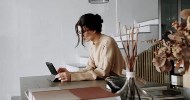 Modern mutfak odasında ve çatı katında dijital tablet kullanan güzel bir kadın. Yaşam tarzı ve eğlence konsepti. Lady Reading e-kitap uygulaması çevrimiçi rahatlatıcı.