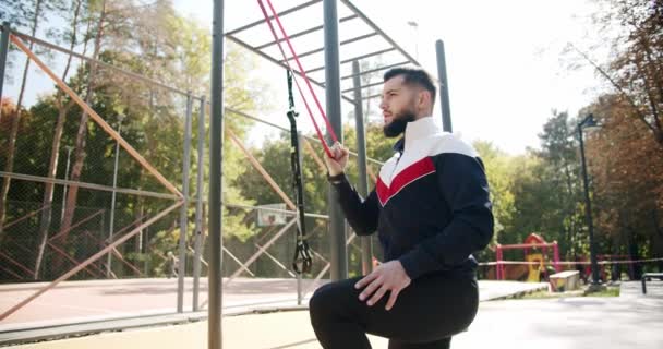 Trainer Male Correcting Fit Does Gym Exercises Rubber Band Outdoor — Vídeos de Stock
