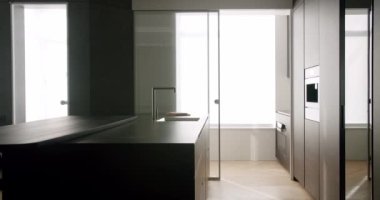 Minimalist Real Apartment. Modern Kitchen Room. Minimalist Furniture with Dining table with modern chairs. Modern Chrome Faucet. New Home. Real Luxury Design Interior. Neoclassic Style, cozy interior.