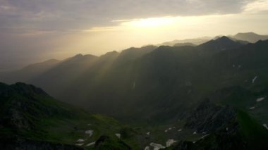 Beautiful sunrise over wild forest mountains in summer morning. Aerial shot of the mountains. Aerial Flight Footage Over Peaks Epic Panorama Nature Success Summit Top Peak
