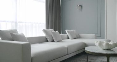 Modern contemporary Minimalist living room with white and gray furniture and round table. Luxury Modern House Interior With Corner Sofa and Bookshelf. Cozy Modern Furniture Design. Luxury Elegant Room