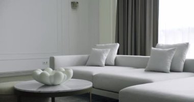 Modern contemporary Minimalist living room with white and gray furniture and round table. Fashionable furniture. Minimalist Home Interior. Cozy Modern Furniture Design. Luxury Elegant Room