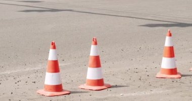 Roadworks signs on a street. Roadworks sign on a road. Repair work on the road. Workers laid new asphalt. work cone static closeup. traffic cones. Road maintenance work cone static closeup.