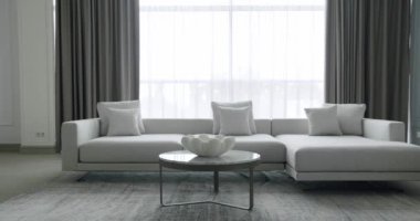 Modern contemporary Minimalist living room with white and gray furniture and round table. Home Interior. Cozy Modern Furniture Design. Luxury Elegant Room. Fashionable furniture. Minimalist room.
