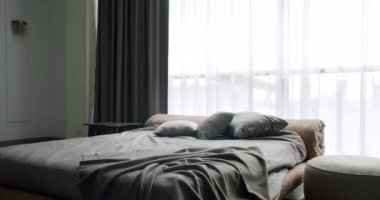 Elegance white and brown interior design. Minimalistic style of interior. Elegant and Simple Bedroom With a King Sized Bed. Interior with shelves on white wall. Luxury bedroom with furniture.