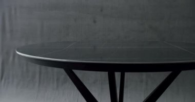 Modern Dining Room Interior with minimalist marble round table. Elegant and Comfortable Home at Dining room. Minimalist black Dining Round Table on isolated grey background. Modern stylish black Table