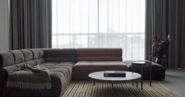 Fashionable furniture. Modern contemporary Minimalist living room with gray and brown furniture. Luxury Modern House Interior With Corner Sofa and round table. Modern Furniture Design. Elegant Room