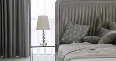 Bedroom Interior and bed with many pillows. Minimalistic style of interior. Simple Bedroom With a King Sized Bed. Modern luxury bedroom with furniture. Elegance interior design.Minimalist Gray Bedroom