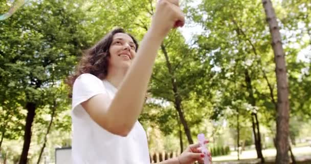 Young Woman Making Large Soap Bubbles Smiling Fashionable Young Caucasian — Video