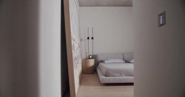 Minimalist bir dairede yatak odası, beyaz tonlarda, modern büyük resim ve siyah lamba ile. Rahat minimalist iç mekan. Şık ev, otel odası, modern mobilya, modern ev tasarımı.