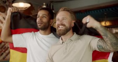 Fans watching football in a bar with friends. World Cup, football, hockey, basketball, sports games. Men with the flag of the national country of Germany drinking beer and watching sport game.