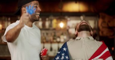 Friends in a Pub. Word Cup Supporters. Happy mixed race supporters cheering and exulting after winning. Men with the flag of the national country of USA drinking beer and watching sport game.